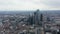 Slow flight above large town. Aerial view of downtown with group of modern skyscrapers in City financial hub. London, UK