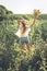 Slow Living concept New Lifestyle Trend. Relaxing young woman with lowers in nature, in corn, sunflower field