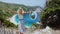Slow Mo of Joyful beautiful blond women raising hands on beach vacation at Kefalonia island, Greece. Happiness lifestyle