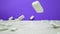 Slow-mo shot of white dominoes fall on a purple background