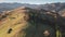 Slow motion aerial of mountain village at autumn pine forest. Nobody nature landscape. Environment