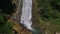 Slow motion aerial shot of big splashing waterfall in summer georgia