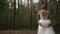 Slow motion as the wedding couple whirls in the woods. Beautiful young wedding couple in beautiful forest. Hugs, kisses