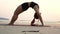 Slow motion of Asian young woman practice Yoga bridge Pose on the sand and beach