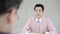 Slow motion - Attractive Asian man during job interview. Businessman in formal wear reading paper documents.