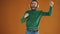 Slow motion of bearded young man listening to music through headphones and dancing having fun enjoying song. Happy youth