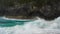 Slow motion blue waves rushing towards sandy beach on a refreshing morning.