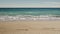 Slow motion blue waves on a sandy empty beach in Cannes in spring