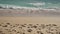 Slow motion blue waves on a sandy empty beach in Cannes in spring