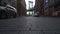 SLOW MOTION: Brooklyn Bridge View from Dumbo with dumbo apartment houses and parked cars on the side in Summer in early