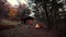 Slow Motion. Burning bonfire in the taiga at night against the background of a wooden hut. Autumn landscape.