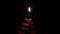 Slow motion burning match in hands in darkness. Close up of male hand holding burning match in pitch darkness