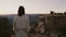 Slow motion camera follows happy excited young woman walking up to amazing sunset Grand Canyon mountain landscape view.