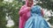 Slow motion of cheerful Asian boy with beautiful smile in raincoat helps his little sister wearing head cover raincoat in rain. A