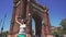 Slow motion of cheerful and beautiful girl spinning around against Arc de Triomf