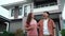 Slow-motion of cheerful couple standing outside their house