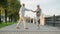 Slow motion of cheerful married couple pensioners dancing smiling having fun in city street