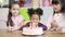 Slow motion - Children celebrate birthday`s party in classroom, Multi-ethnic young girls happy make a wish blow out candles on