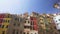 slow motion of Cinque Terre coast in Liguria, Italy. Sea, characteristic colored building, people laying on seaside