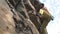 Slow motion climbing moments and details. athletic man rock climber with naked torso climbs on a cliff