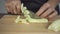 Slow motion - Close up of chief woman making salad healthy food and chopping cucumber on cutting board in the kitchen