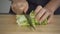 Slow motion - Close up of chief woman making salad healthy food and chopping lettuce on cutting board in the kitchen