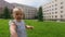 Slow motion close up: cute baby girl walking in the city park and exploring world aroun her, summer sunny day.