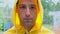 slow motion close up front view Man yellow raincoat under heavy rain bad weather