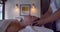 Slow motion close up gentle hands of masseuse making head massage in spa for young girl lying face up enjoying healthful