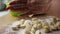 Slow motion. Close-up of homemade Russian fresh dumplings crumbling on the table. Freshly molded dumplings are poured