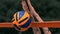 Slow motion, close up, low angle: unrecognizable young female` hands playing volleyball at the net. Offensive player