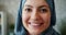 Slow motion close-up portrait of beautiful Muslim girl smiling in office