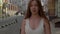 Slow motion. Close-up portrait. emotional video attractive caucasian white girl walks through the old city. Tourist in a