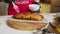 Slow motion close up shot of chef brushing melting butter on baked whole wheat homemade bread on the table. Vercion 3