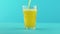Slow motion close-up shot of fruit fizzy orange soda cold beverage drink pooring into faceted glass on colored blue
