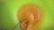 Slow motion close-up of someone preparing a homemade omelet or for baking mix eggs with a metal whisk in a plastic bowl. The proce