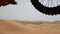 slow motion close up view of flying motorbike from sand dune and floating in the air