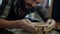 Slow motion close-up of young professional potter making bowl from clay on throwing wheel