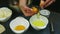 Slow motion closeup chef hands separate yolk from protein of single raw egg