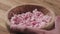 Slow motion closeup eating cottage cheese with cowberry jam in wood bowl