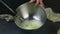 Slow motion closeup female hands whisking egg whites by whisk in metal bowl