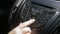 Slow motion closeup footage of female hand adjusting radio sound level on car multemedia system