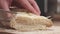 Slow motion closeup slicing fresh baguette on cutting board