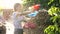 Slow motion closeup video of wet teenage girl shooting water from toy gun during water fight at backyard