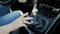 Slow motion closeup video of young woman shifting car manual gearbox