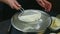 Slow motion closeup woman hands hold metal sieve full with white flour ready to sift it