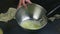 Slow motion closeup woman hands whisking egg whites by whisk in deep metal bowl