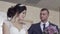 Slow motion closeup young fiance touches bride open shoulder