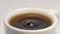 SLOW MOTION: Coffee drop falls to a white cup