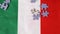 In slow motion, colorful jigsaw puzzle pieces fall on the Italian flag. The concept of Italian puzzle manufacturers.